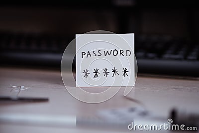 Secret password written on paper note on keyboard with wooden desk on background. Login access, encryption and cyber security con Stock Photo