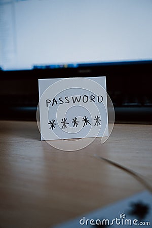 Secret password written on paper note on keyboard with wooden desk on background. Login access, encryption and cyber security con Stock Photo