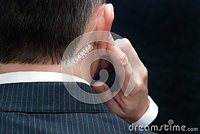 Secret Service Agent Listens To Earpiece, Behind Stock Photo