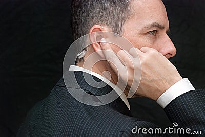 Secret Service Agent Listens To Earpiece, Side Stock Photo