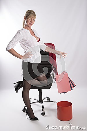 Secretary dropping paper into waste bin Stock Photo