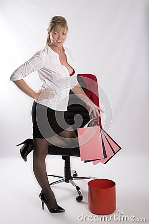 Secretary dropping paper into waste bin Stock Photo