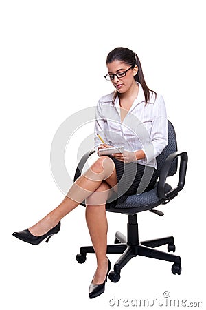 Secretary sat on an office chair taking notes. Stock Photo