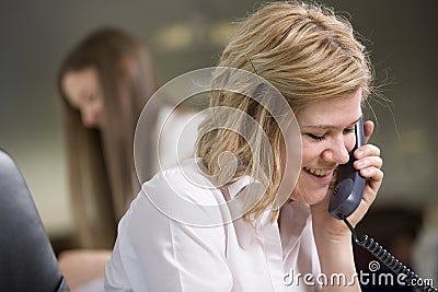 Secretary taking notes over the Phone Stock Photo