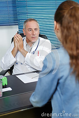 Secretary talking to doctor in office Stock Photo