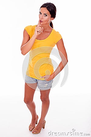 Secretive gesturing don't tell young woman Stock Photo