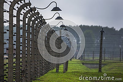 A section of the barbed wire electric fence which surrounded the Auschwitz-Birkenau Concentration Camp at Oswiecim in Poland. Editorial Stock Photo