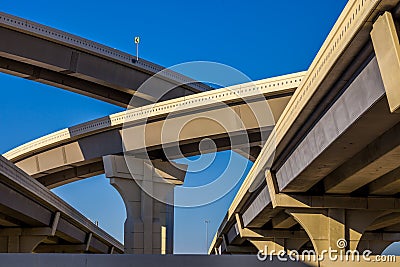 Section of elevated highway with several levels against a bright blue sky in Houston, Texas Stock Photo