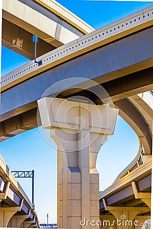 Section of elevated highway with several levels against a bright blue sky Stock Photo