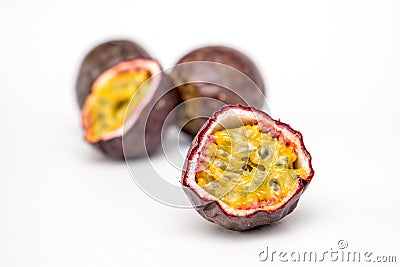 Section of a passion fruit with colourful seeds on a white background Stock Photo