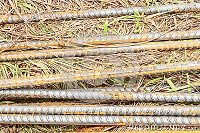 Section of ten metal, rusting rebars, on the ground Stock Photo