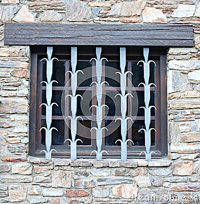 Secure metal patterned lattice is installed on the window of the stone structure Stock Photo