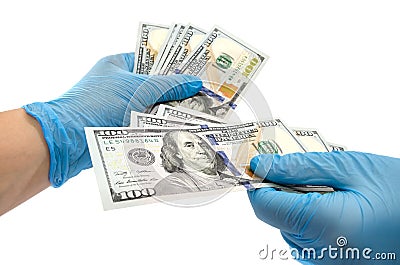 Secure money transfer.hand in rubber glove takes money.hands in sterile medical gloves concept on theme of corruption in medicine Stock Photo