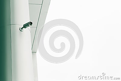 Security camera mounted on the facade of the modern building. Stock Photo