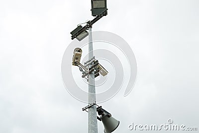 Security CCTV cameras and loudspeaker mounted on the post for street surveillance. Stock Photo