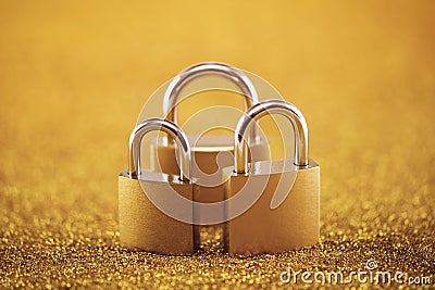 Security concept with three padlocks over golden background Stock Photo