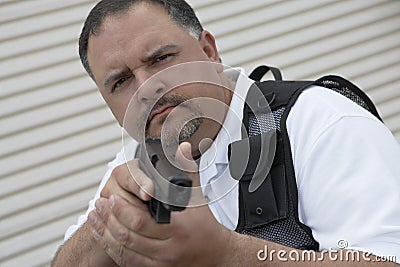 Security Guard In Bulletproof Vest Holding Gun Stock Photo