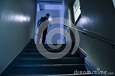 Security Guard With Flashlight Stock Photo