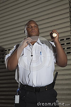 Security Guard Patrols At Night Stock Photo