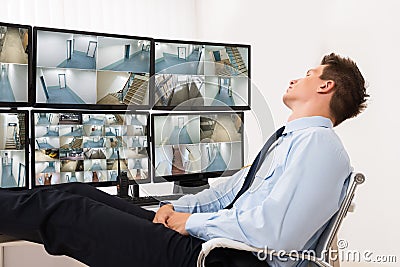 Security Guard Sleeping In Control Room Stock Photo