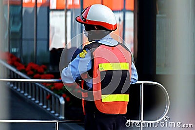 A security guard standing, catching a stainless bar Editorial Stock Photo