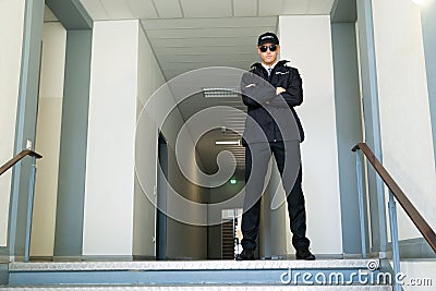 Security Guard Standing At The Entrance Stock Photo