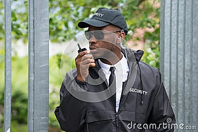 Security Guard Using Walkie-Talkie Stock Photo