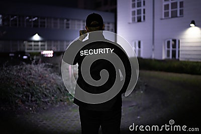 Security Guard Walking Building Perimeter Stock Photo