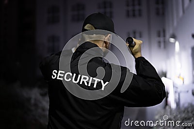 Security Guard Walking Building Perimeter Stock Photo