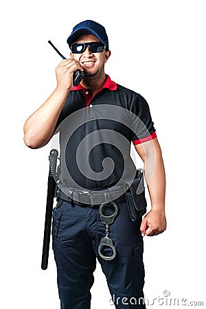 security guard wears dark glasses and wears a hat.holding a walkie-talkie with rubber batons ready and handcuffs on a tactical Stock Photo