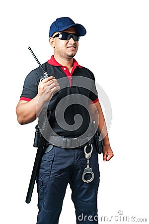 security guard wears dark glasses and wears a hat.holding a walkie-talkie with rubber batons ready and handcuffs on a tactical Stock Photo