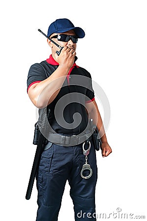 security guard wears dark glasses and wears a hat.holding a walkie-talkie with rubber batons ready and handcuffs on a tactical Stock Photo