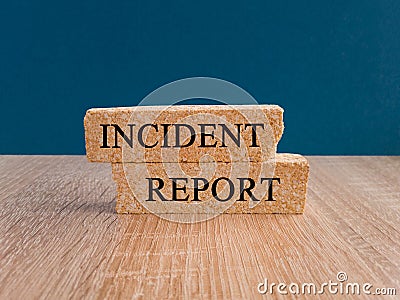 Security and insurance concept. Brick blocks with the inscription - Incident report on beautiful blue background, wooden table. Stock Photo