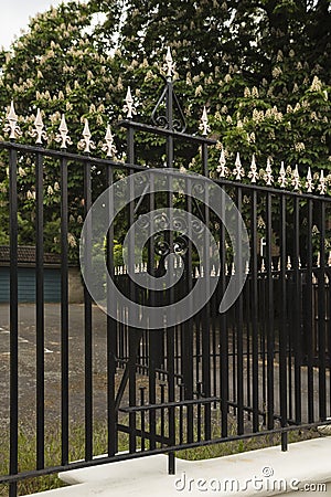 Security: Ornate, gold spear topped, fence made of black railings. 2 Stock Photo