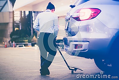 Security personnel are checking safty under the car. befor entering the hotel parking lot Editorial Stock Photo