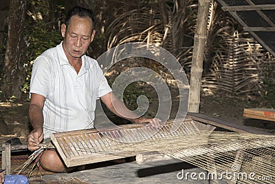 People weaving sedge grass mats. Editorial Stock Photo