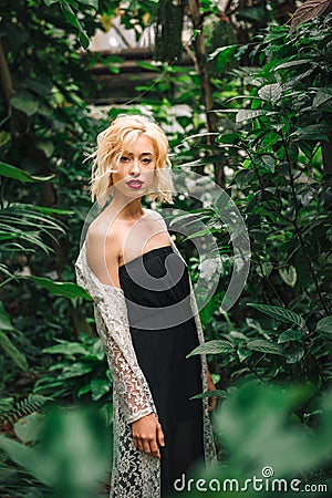 Seductive blonde female model at the rainforest Stock Photo