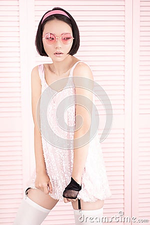 Seductive brunette asian woman in sexy shiny dress Stock Photo