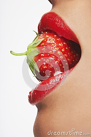 Seductive Woman Biting Strawberry Stock Photo