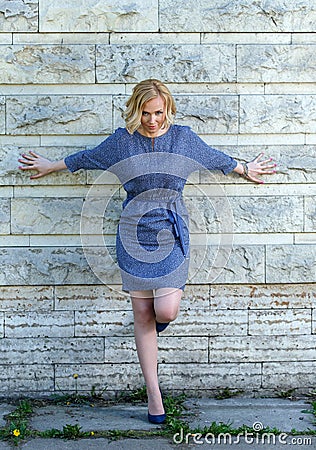 Seductive young blond posing near stone wall Stock Photo
