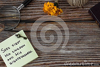 Seek first His kingdom and righteousness verse with ancient key, magnifying glass, Bible Book on wooden background, copy space Stock Photo