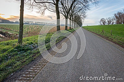 Seemingly endless country road during sunset Stock Photo