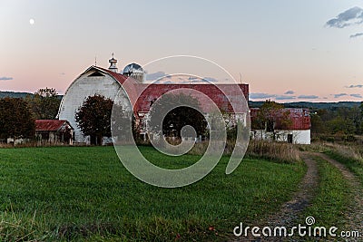 Abandoned Dairy Barn + Dirt Road at Sunset - West Virginia Stock Photo