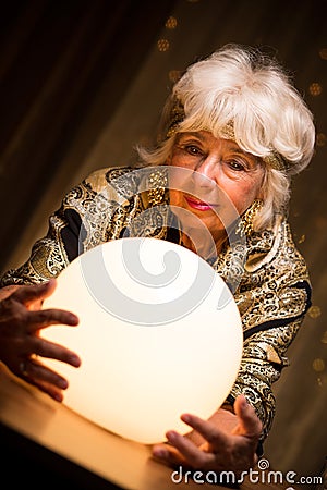 Seer holding crystal ball Stock Photo