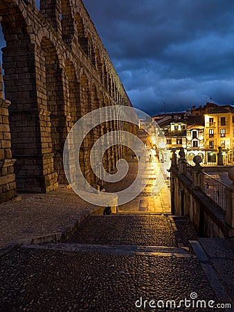 Segovia, Spain at the ancient Roman aqueduct. The Aqueduct of Segovia, located in Plaza del Azoguejo, is the defining historical f Stock Photo