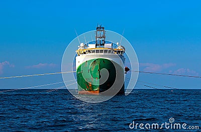 Seismic survey vessel from straight ahead with all towed in sea equipment deployed. Oil and gas exploration Stock Photo