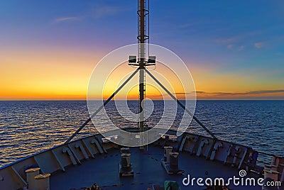 A Seismic Vessel heading East at Dawn with the Sun about to rise Stock Photo