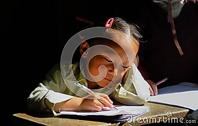 SEKHA, SANKHUWASABHA DISTRICT, NEPAL - 11/19/2017: school girl doing homework Editorial Stock Photo