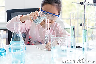 Select focus. Asian children analyzing study evaluating microscope with scientist. Stock Photo