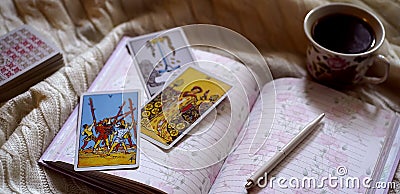 Selected focus of tarot cards layout, cup of Coffee and notebook. Editorial Stock Photo